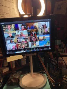 Image displaying multiple people smiling on a Zoom classroom.